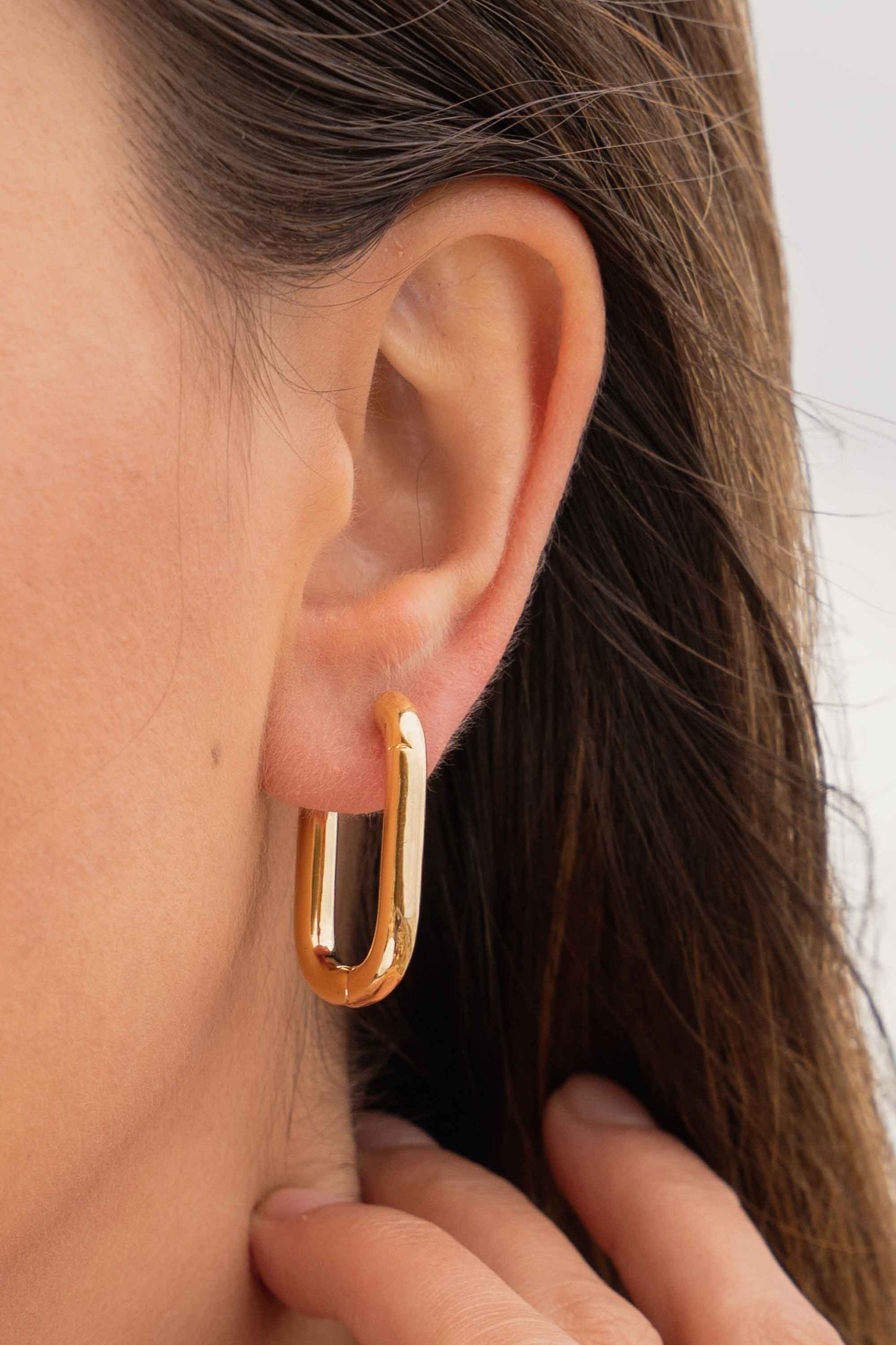 chunky-oval-geometric-chubby-statement-gold-hoop-earrings-on-body-close