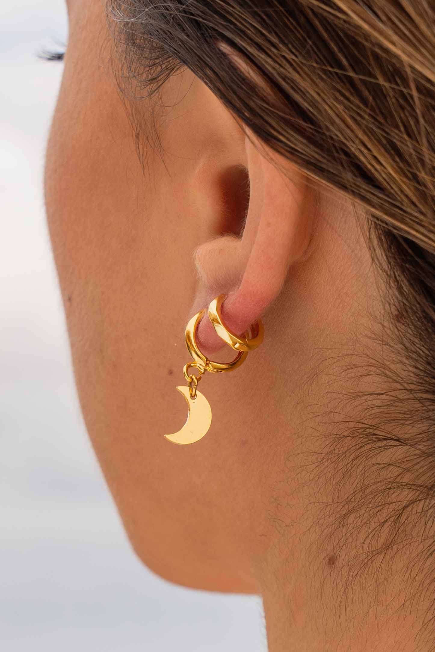 crescent-moon-gold-hoop-huggie-earrings-close-up