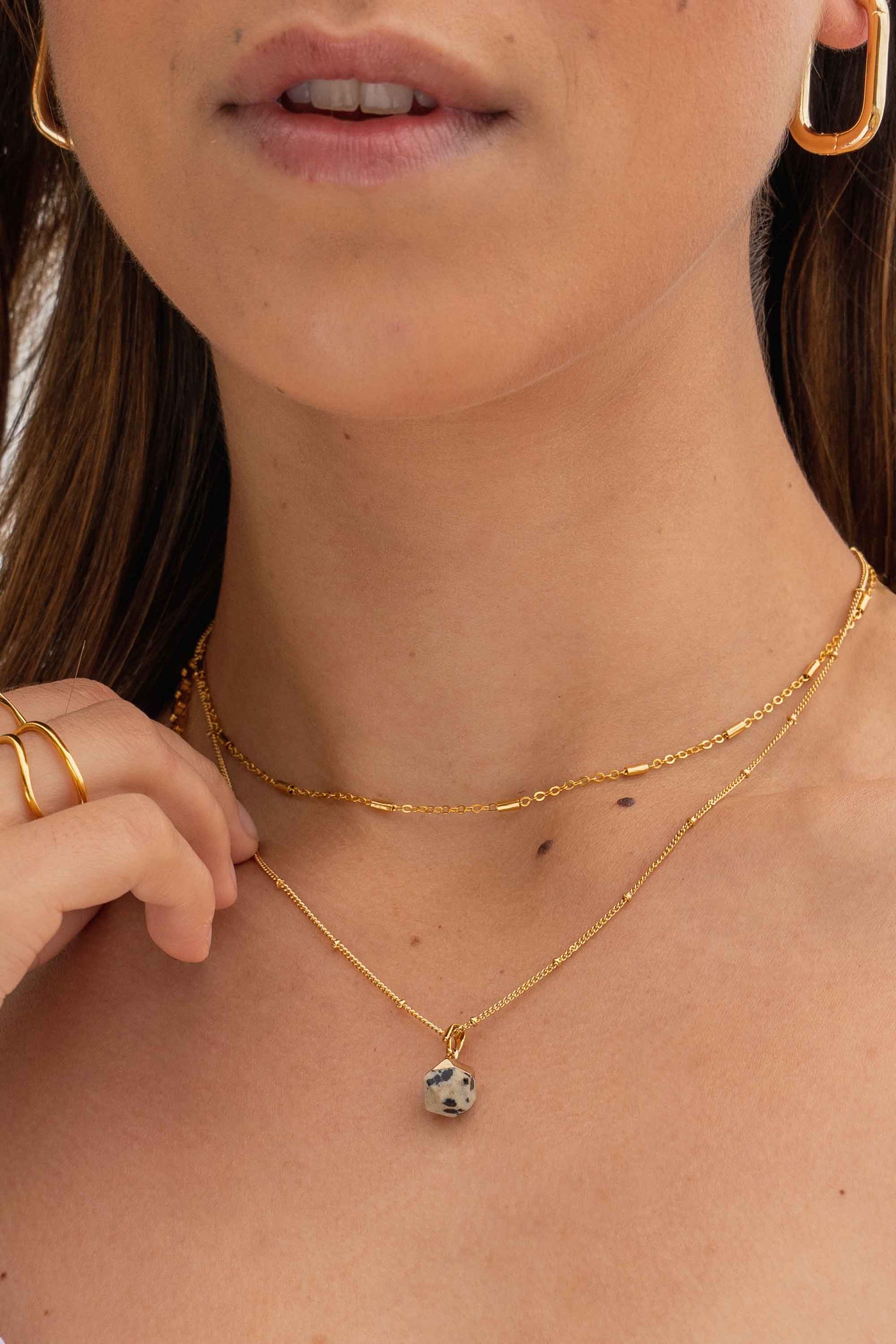 dalmatian-jasper-geometric-stone-delicate-necklace-gold-on-body-close