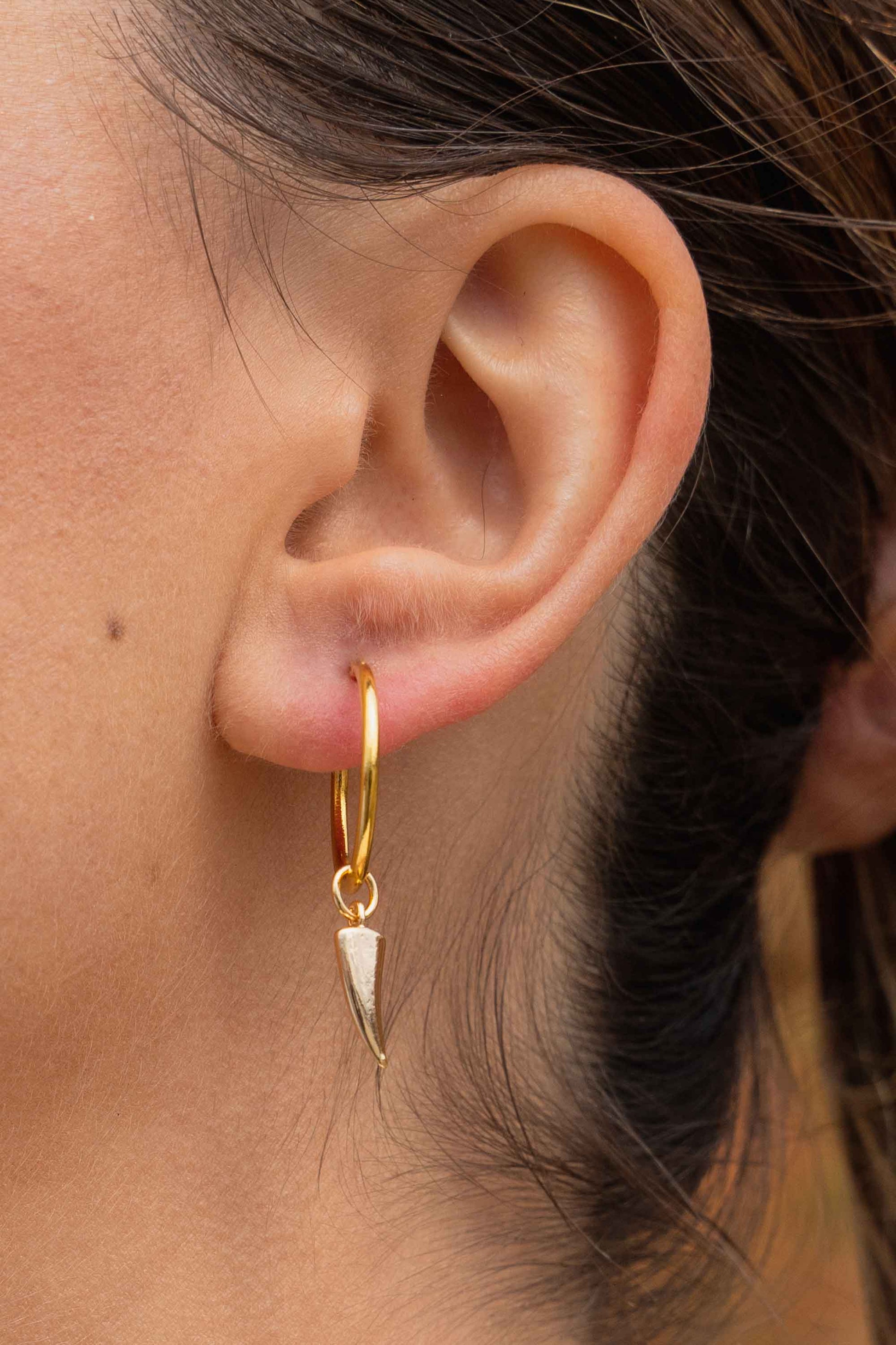 horn-charm-gold-classic-hoop-earrings-on-body-close