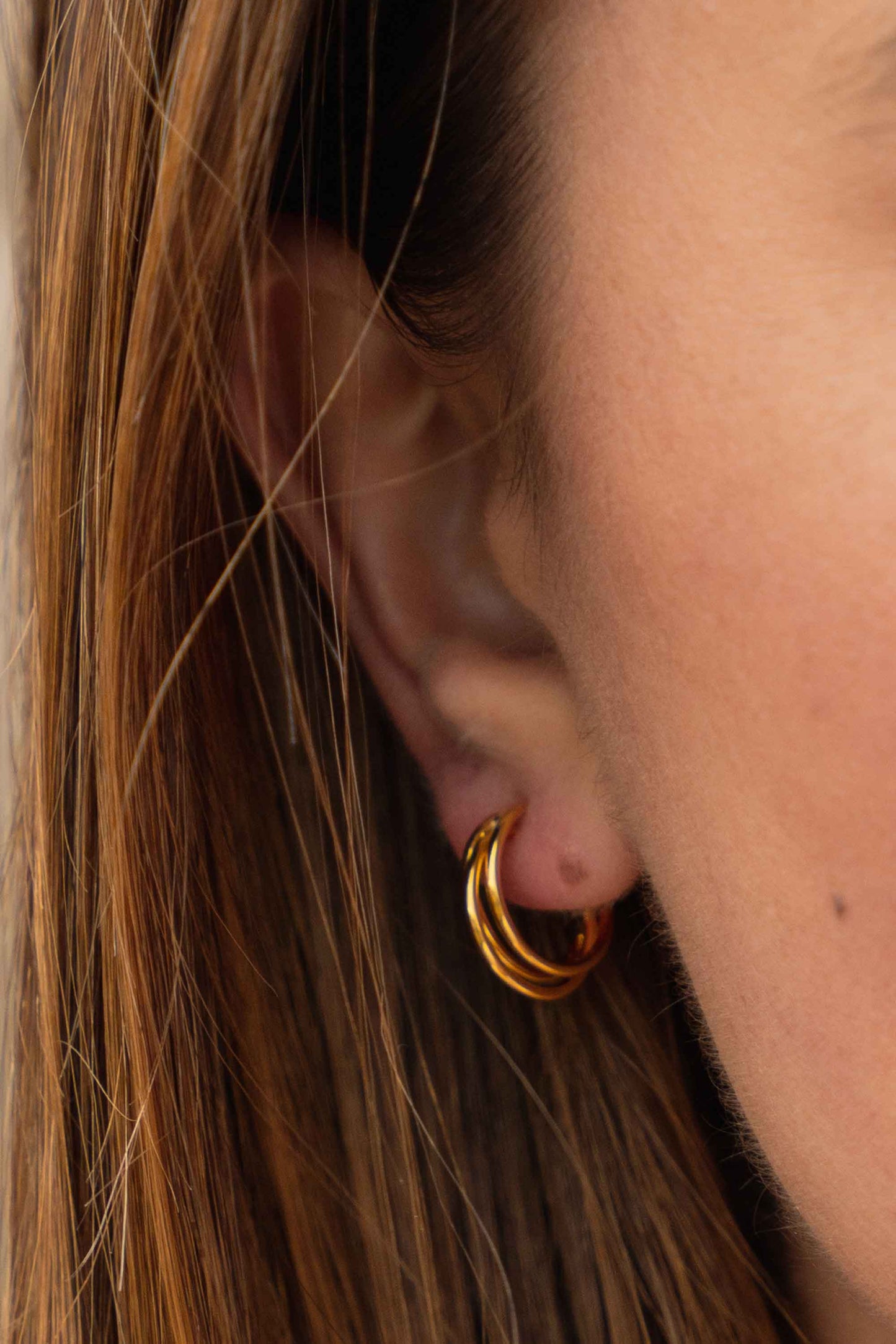 tri-prong-classic-retro-gold-hoop-earring-on-body-close
